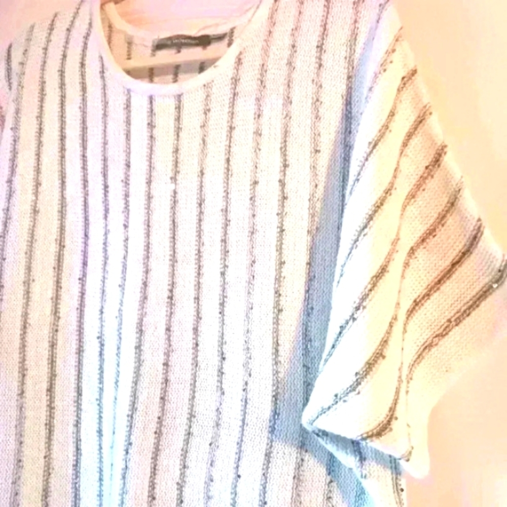 White Boho sweater with fringe. Sequin detail Dolman sleeves.